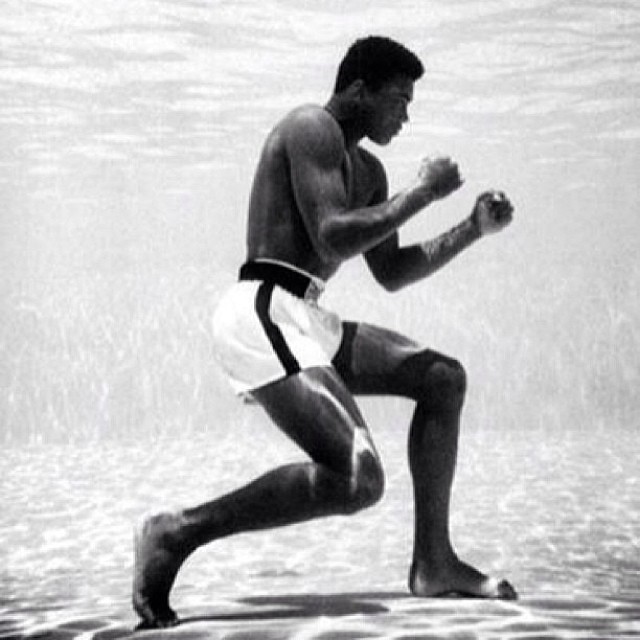 Muhammad Ali in a boxing stance while underwater