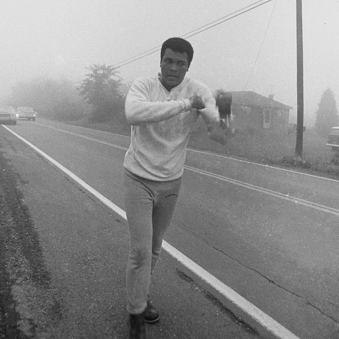 Muhammad Ali running and shadowboxing