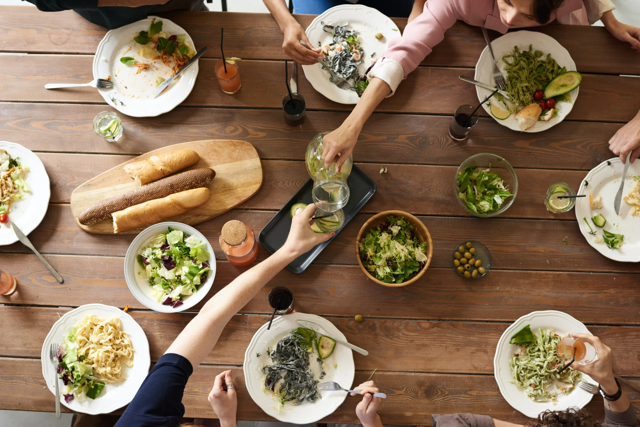 people enjoying a meal over a dining table