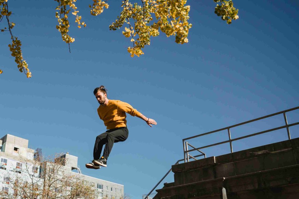 Active man jumping from high structure